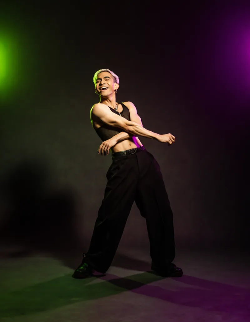 Studio portrait of Kris Halbach, flash-lit against a dark backdrop.