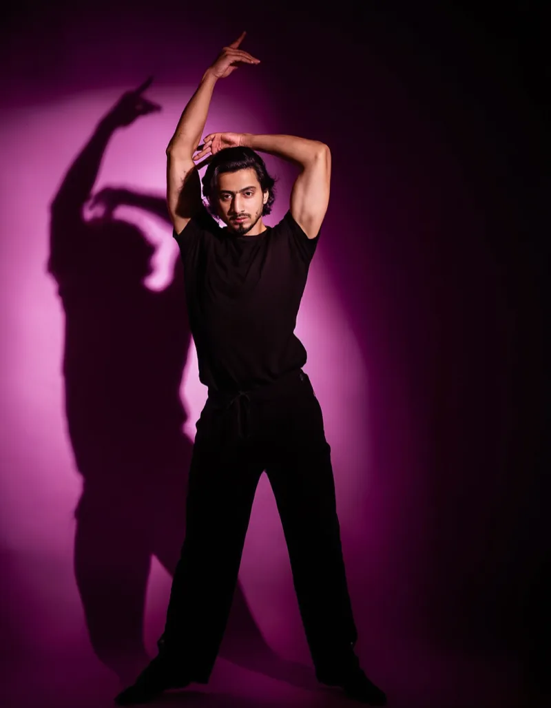 Studio portrait of Ruben Salgado, flash-lit against a dark backdrop.